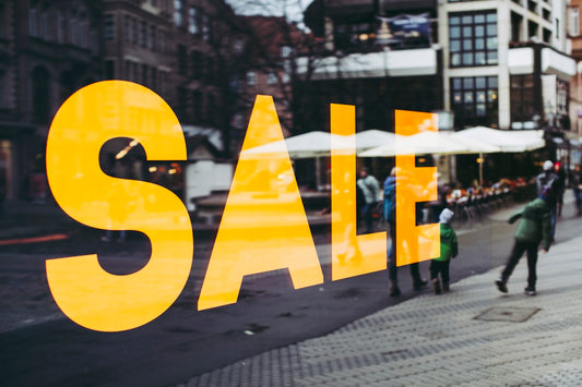 Yellow SALE sign on a shop window overlooking a pedestrian street in Nürnberg